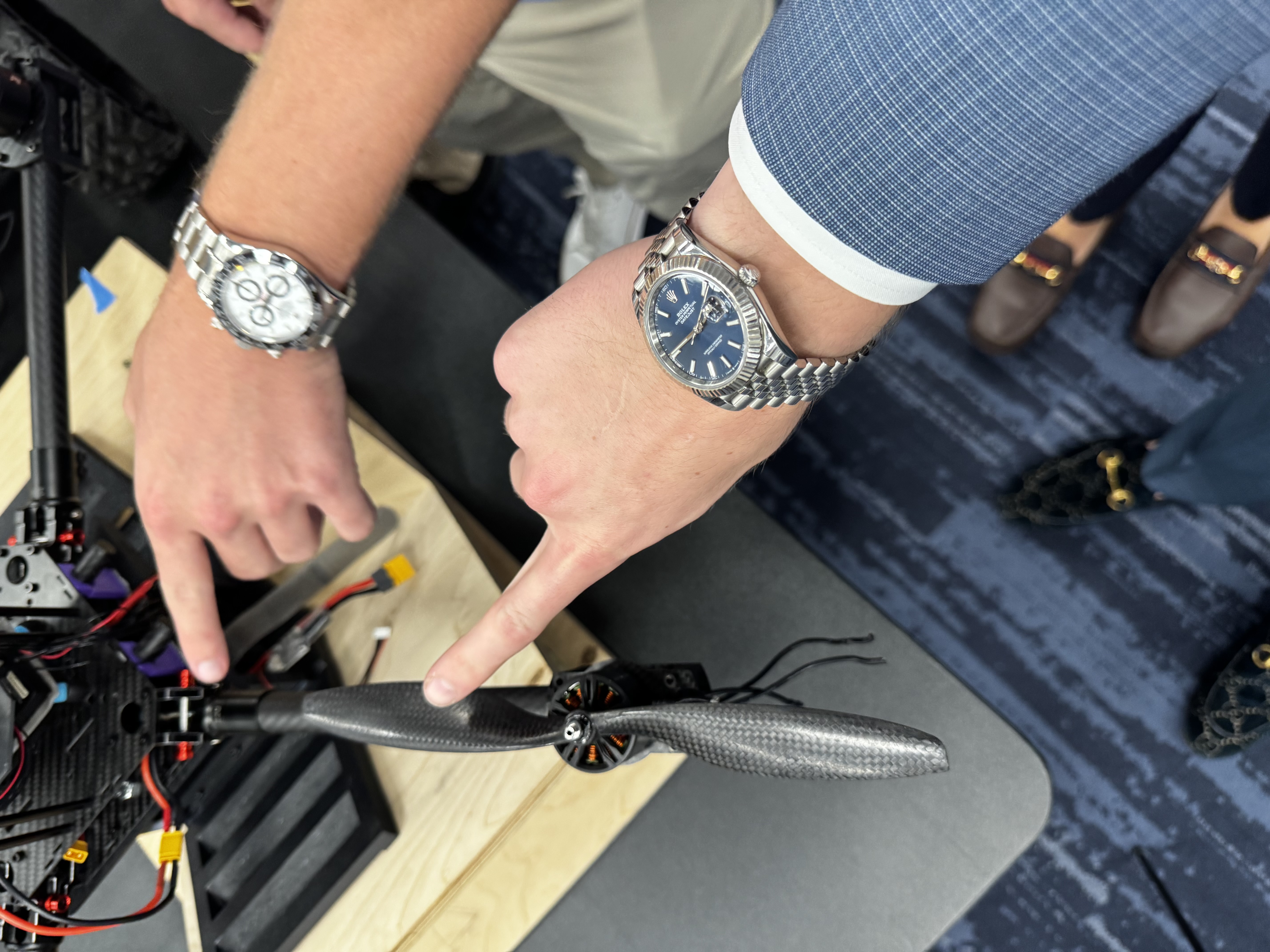 Technical project image featuring a carbon-fiber propeller and engineering hardware